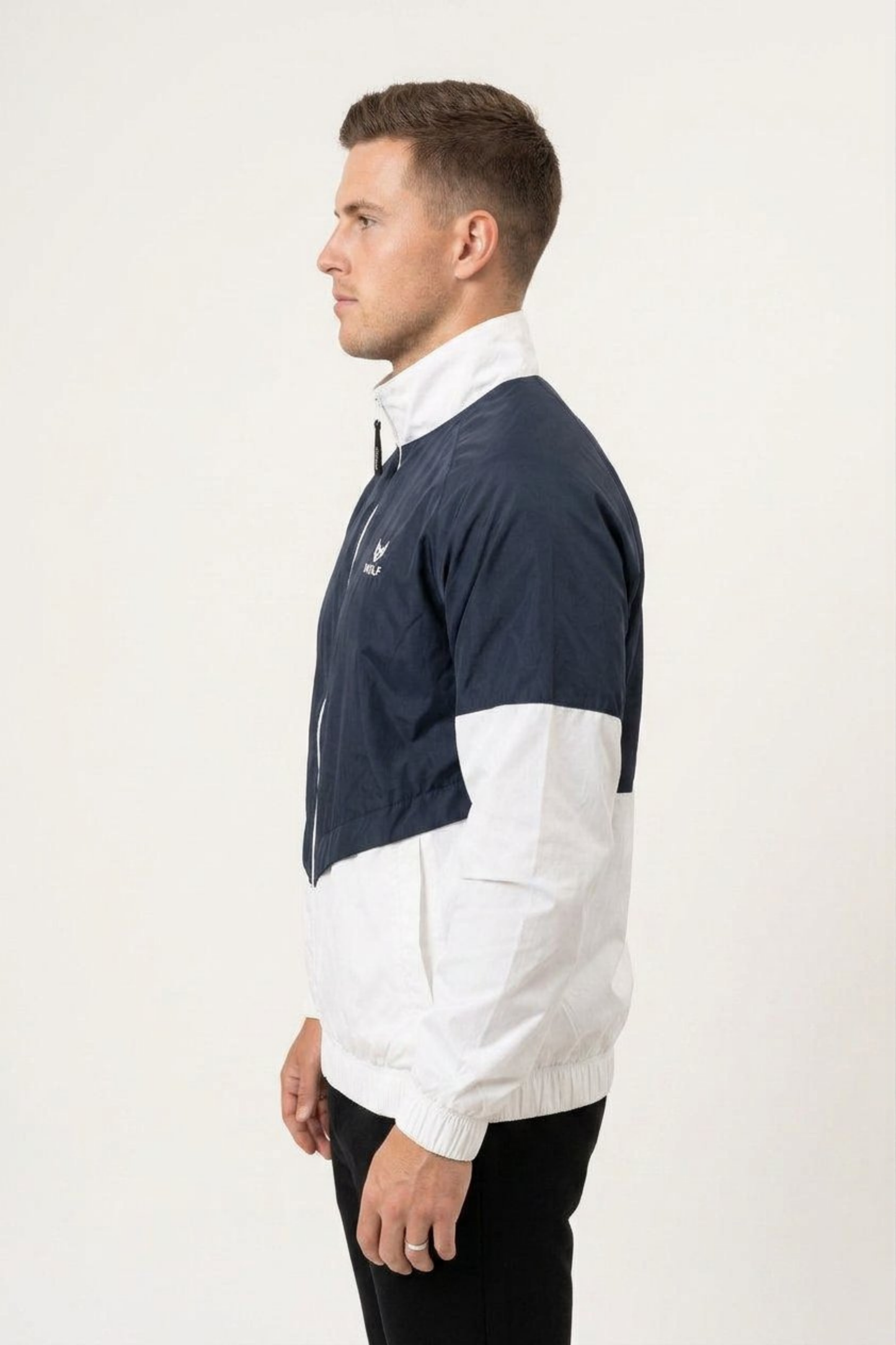 Side view of men’s navy and white two-tone lightweight windbreaker with raised collar