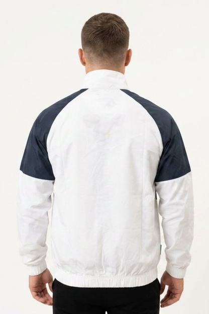 Back view of men’s navy and white two-tone windbreaker jacket with elasticated hem