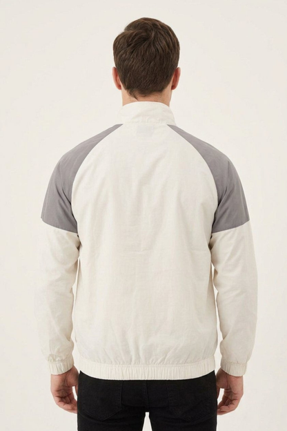 Back view of men’s grey and white two-tone lightweight windbreaker with elasticated cuffs a