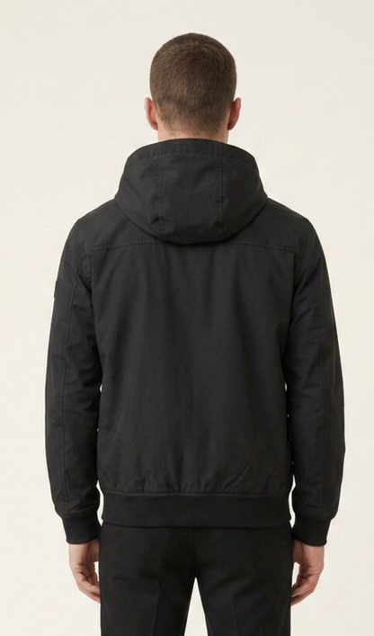 Back view of men’s solid-black hooded windbreaker jacket with ribbed hem and long sleeves